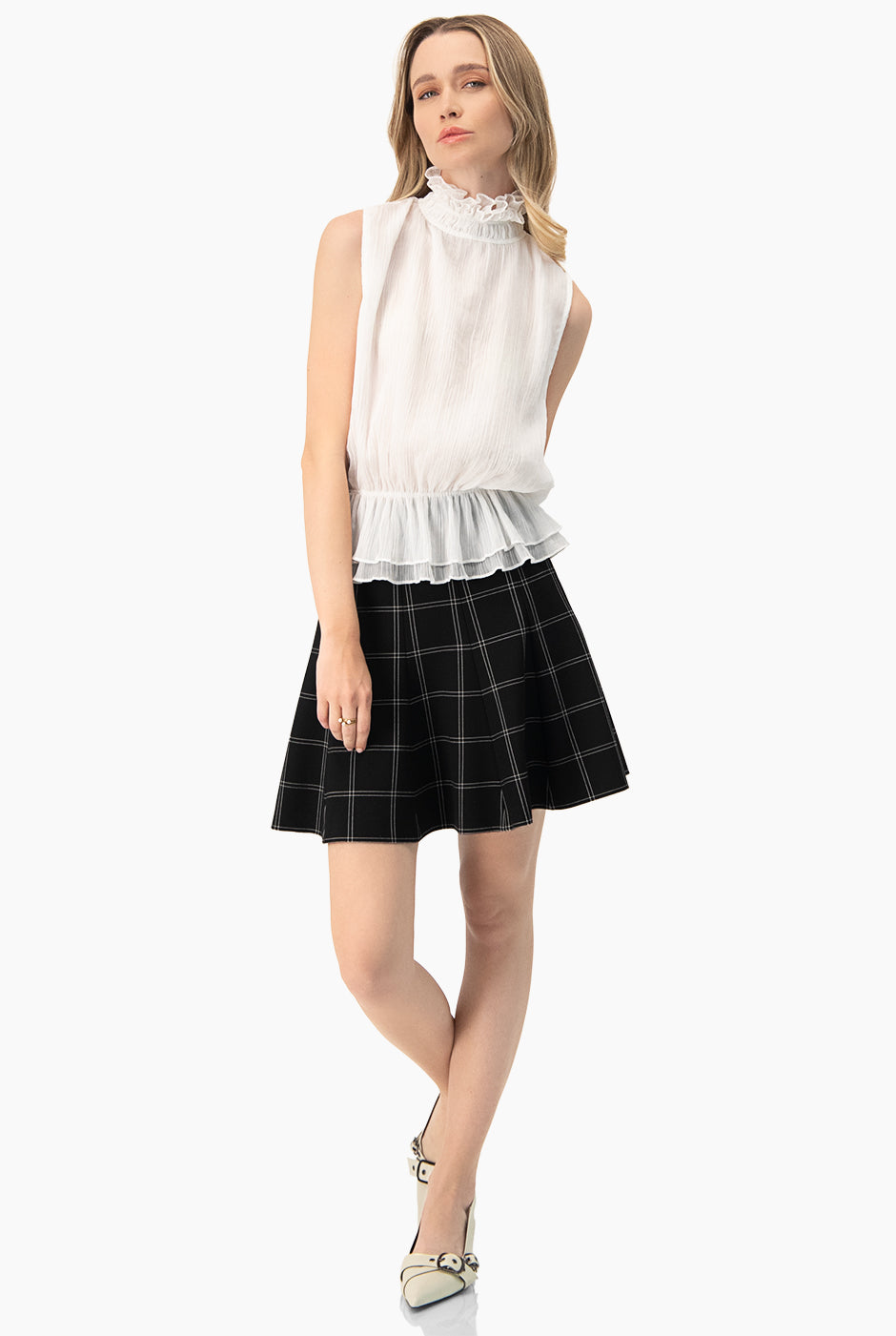 Blusa blanca de cuello alto y sin mangas con detalle plisado